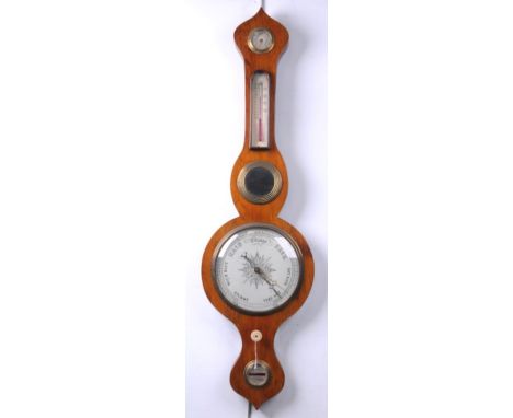 A Rosewood veneered wheel barometer 19th Century
With a 19cm register, level mirror, thermometer and hygrometer within an oni
