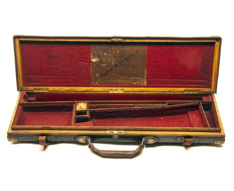 COGSWELL & HARRISONA BRASS-CORNERED OAK AND LEATHER SINGLE GUNCASE,fitted for 30in. barrels, the interior lined with red baiz