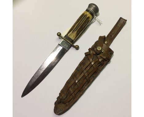 A post war German made hunting knife with stainless steel double edged 14cm blade by "Anton Winger, Jr, Solingen, Germany", t