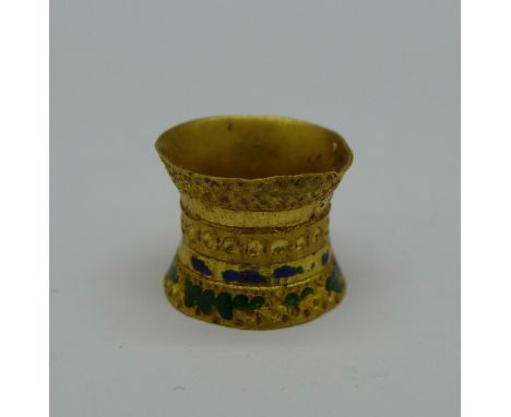 A yellow metal and enamel metal detecting find, 1.5g