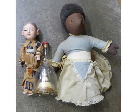 A Japanese celluloid doll, a musical ballerina decanter and a hedgehog door stop