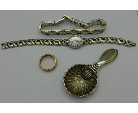 A caddy spoon, a silver ring, a silver wristwatch and a silver bracelet