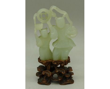 A Chinese carved jade figure on a carved wooden stand, a/f, 9.5cm with stand
