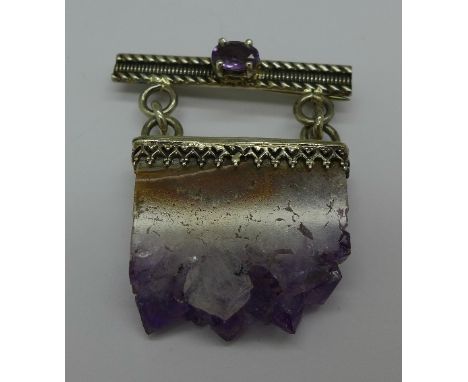 A silver and amethyst mineral specimen brooch