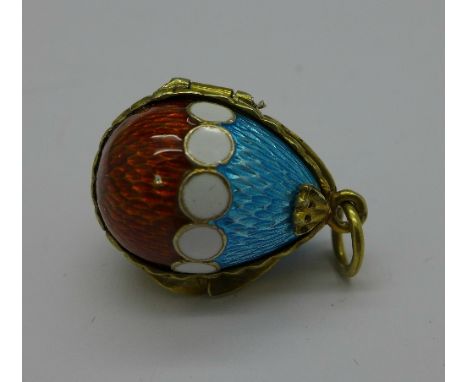 A silver and enamel egg pendant or charm