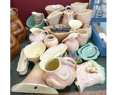 A large collection of Sylvac pottery, including vase, jugs, etc., a novelty condiment and a Sylvac Ceramics display plaque