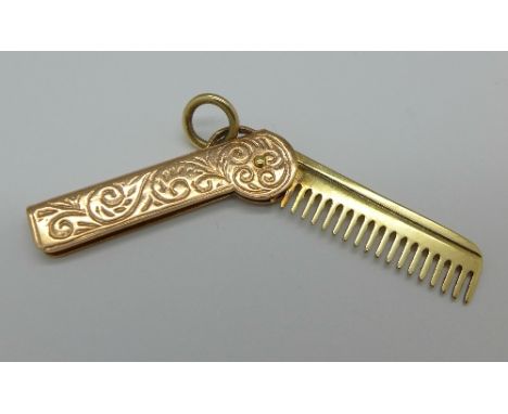 A hallmarked 9ct gold folding comb charm, 2.4g