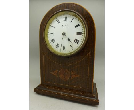 An oak cased arch top mantel clock, retailed by W.H. May, Nottingham, the movement marked France, 20.5cm