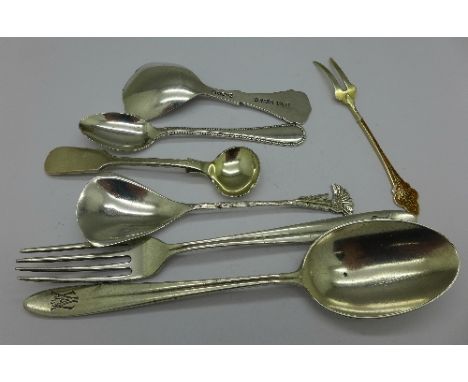 An Arts and Crafts caddy spoon, a continental silver fork and matching spoon, etc.