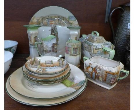 A collection of Royal Doulton Dickens tea ware including a three piece service and a pair of candlesticks, a/f, fifteen in to