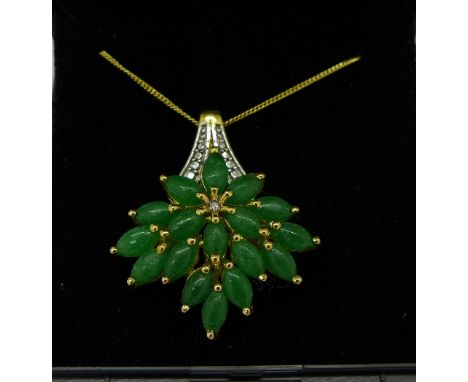 A silver gilt, jade and diamond pendant