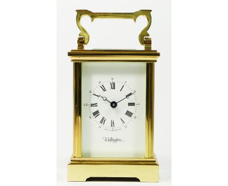 A mid 20th century English carriage clock, brass case with bevel edge glass panels, housing a jewelled 8 day movement, inscri