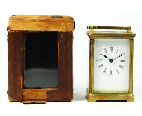 An 8 day brass carriage clock Circa 1930s, complete with fitted traveling case (distressed) and key.13cm tall. 
