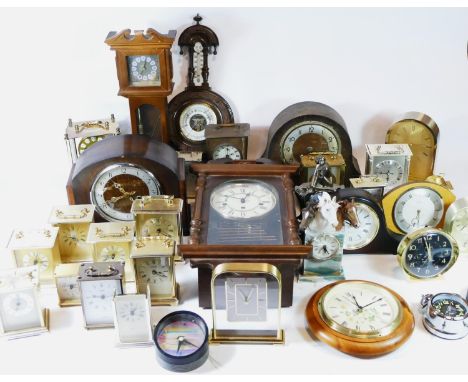 A collection of mid 20th century mantel clocks and barometers, together with traveling alarm clocks and miniature novelty clo