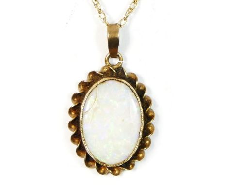 A 9ct gold opal pendant, 14 x 10mm, chain 