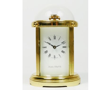 A London Clock Co brass carriage clock, of circular form with bevel edge glass panels and domed glass top, incorporating a Sw