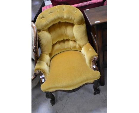 A Victorian button back nursing chair having mahogany knurl frame and gold dralon upholstery
