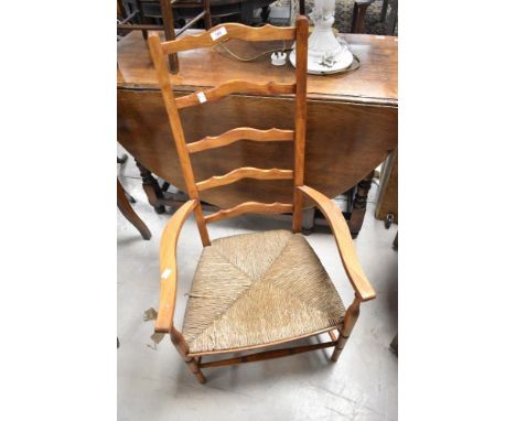 A rush seated ladder back carver chair