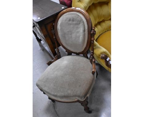 A Victorian button nursing chair having mahogany frame, shield back and beige dralon upholstery