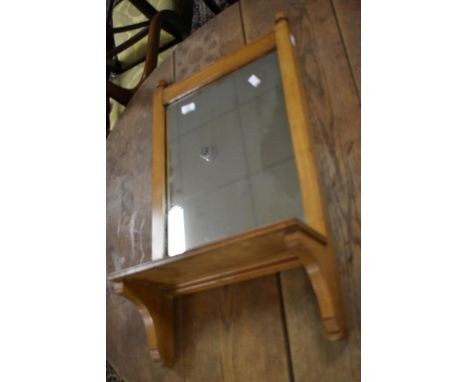 A Victorian hall mirror with shelf under