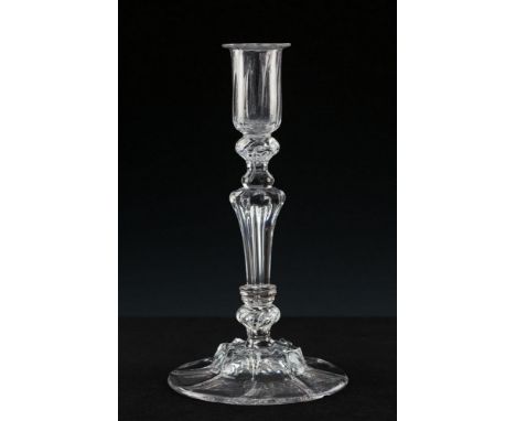  An early 18th century glass candlestick circa 1725, the cylindrical ribbed sconce set on beaded knop collar, moulded octagon