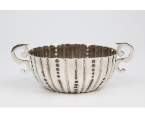  A Victorian silver twin handled christening bowl Charles Stuart Harris, London 1884, of shallow cup form with flute and bead