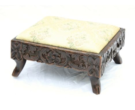  A 19th century carved oak low stool the drop-in seat in a foliate and floral carved frame, on hoof feet, 15 x 12¾in. (38 x 3