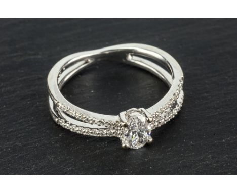  An 18ct white gold and diamond ring the approx. 0.5 carat oval cut diamond of good clarity and colour, on a splat shank, the