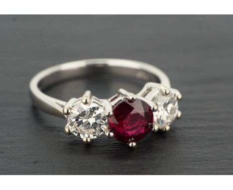 An 18ct white gold, unheated ruby and diamond three stone ring the central 1.18 carat ruby of good clarity and colour, flank