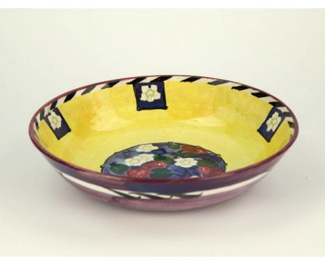  A ceramic bowl by Elizabeth Amour c.1921, yellow glazed interior with apple and blossom scene in circular reserve, black and