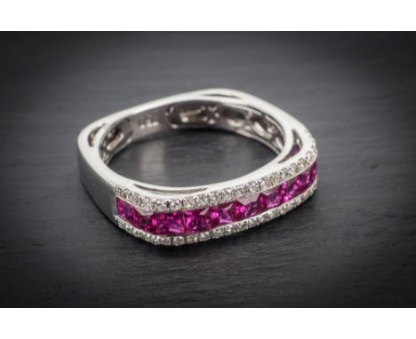  An 18ct white gold, ruby and diamond eternity ring the squared section ring channel set with eleven princess cut rubies, tot