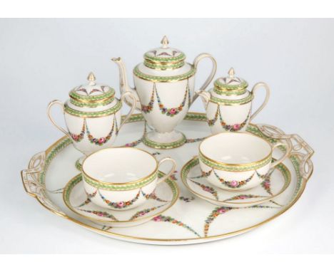  A Continental porcelain tête-a-tête cabaret set 20th century, comprising 15in. circular tray with pierced handles, two cups 