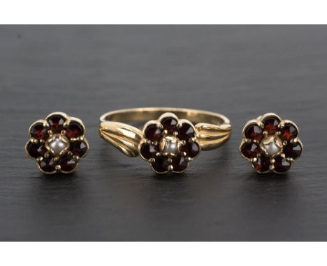  A 9ct yellow gold, ruby and seed pearl ring in a floral cluster within foliate shoulders, ring size M½, together with a pair