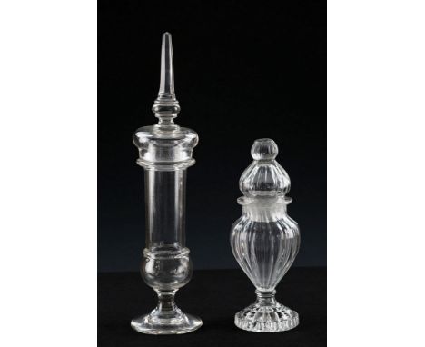  An early 19th century glass baluster spice jar the urn form jar and domed cover with moulded fluted decoration, on a deeply 