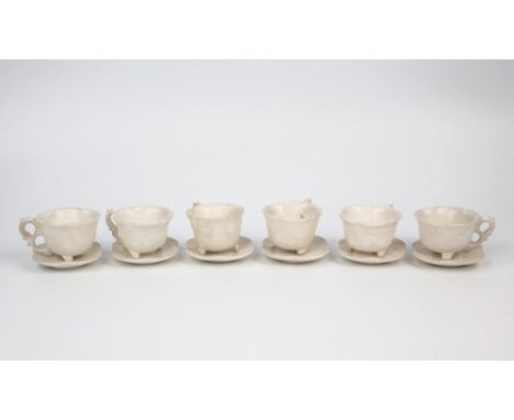  A set of six Chinese carved white stone cups and saucers probably early 20th century, the cups of lotus form with s-scroll d