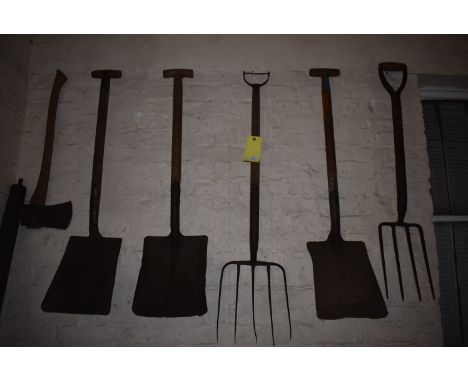 Items on Wall Three Shovels, Two Forks, and an Axe