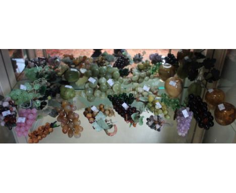 A shelf containing a wide selection of glass fruit