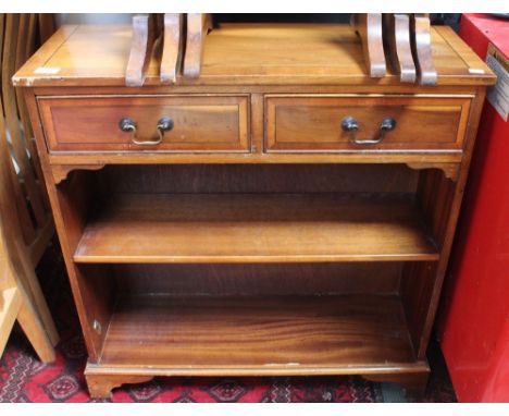 A reproduction yew wood two drawer book shelf