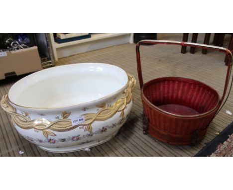 A Victorian floral decorated pottery planter with old staple repairs together with a red wicker basket
