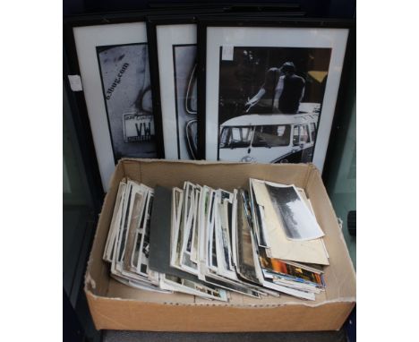A shelf containing a selection of black &amp; white postcards, together with five framed prints and a photograph album