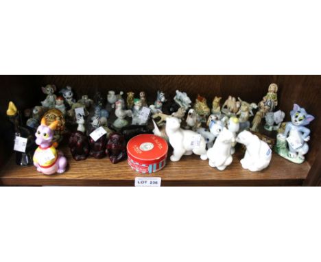 A shelf containing a wide selection of animal models to include Wade Whimseys etc