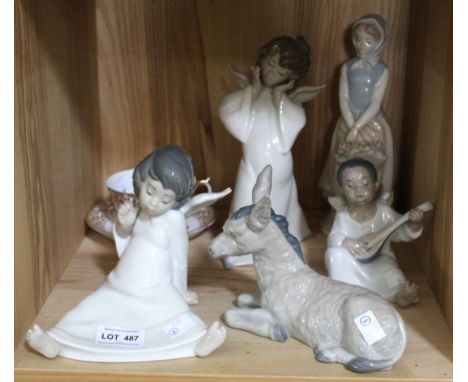 A collection of Lladro and Nao ceramic figures, includes Angels and a donkey, together with an Indian Tree cup and saucer