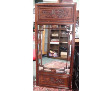 A hardwood Chinese inspired over mantel mirror with carved side panels