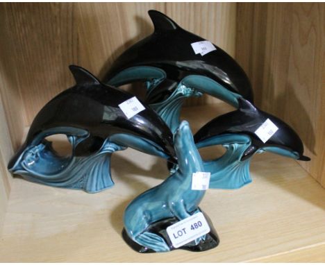 Three Poole Pottery dolphin figurines and a sealion (4)
