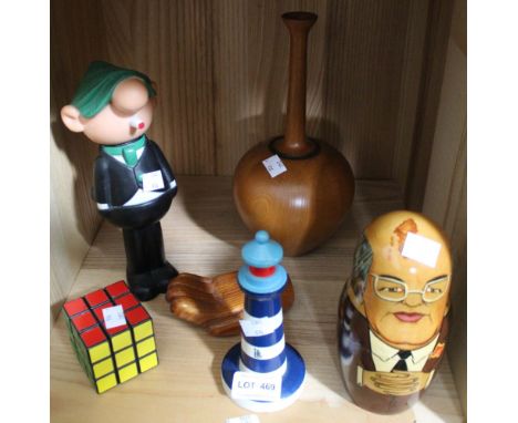 A shelf of collectibles including Andy Capp, a Rubix cube etc