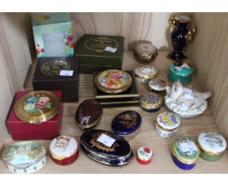 A shelf of compacts, trinket boxes and ceramic ornaments