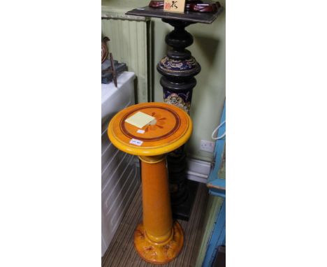 An ebonised and continental ceramic decorated plant stand together with a sunshine yellow ceramic example
