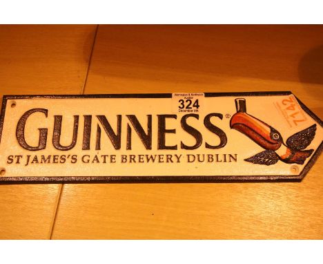 Cast iron Guinness Toucan arrow sign, L: 38 cm. P&amp;P Group 1 (£14+VAT for the first lot and £1+VAT for subsequent lots) 