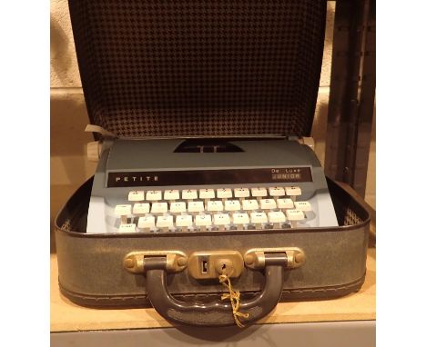 Cased blue petite child's typewriter with key. P&amp;P Group 2 (£18+VAT for the first lot and £3+VAT for subsequent lots) 