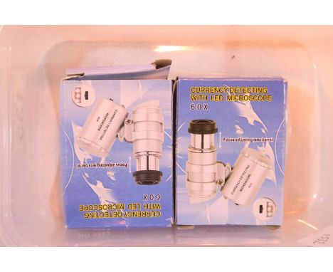 Two boxed 60x jewellers loupes with LED light and leather case. P&amp;P Group 1 (£14+VAT for the first lot and £1+VAT for sub